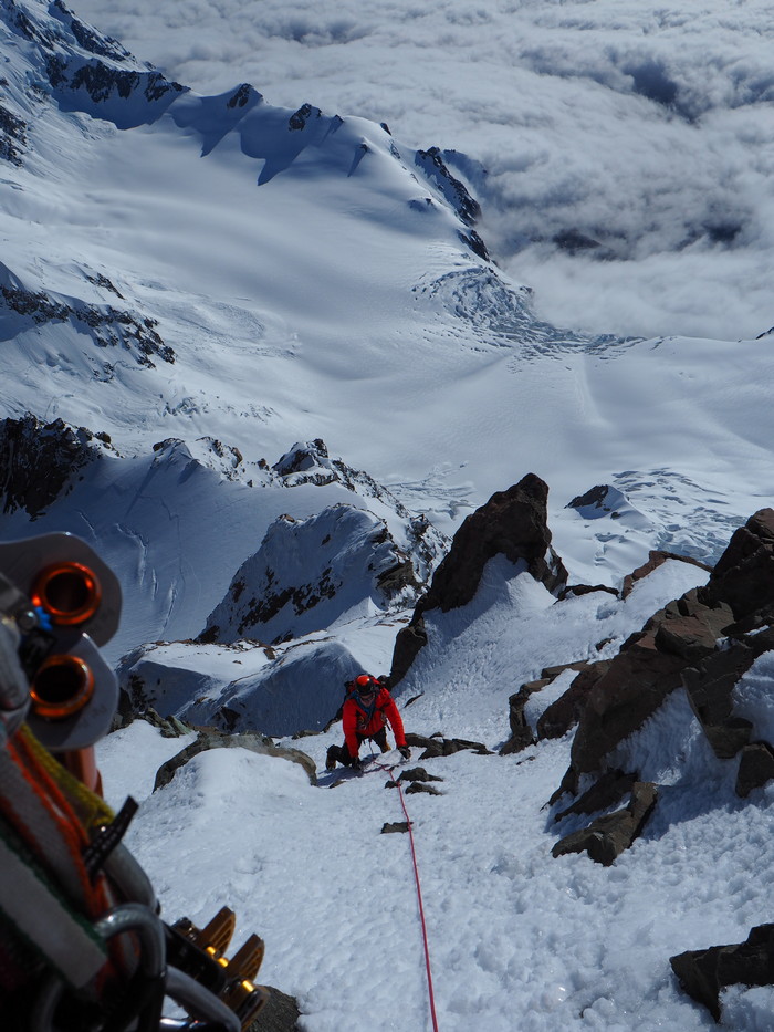 Climb Aoraki / Mt Cook - climbing through the summit rocks towards the summit ice camp in good early season conditions